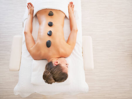 Young woman laying on massage tableの写真素材