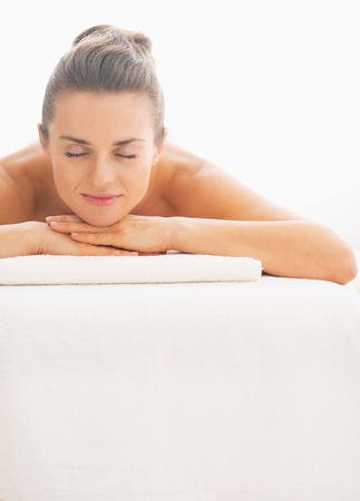 Portrait of young woman laying on massage tableの写真素材