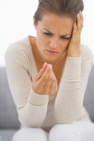 Frustrated young woman looking on pillの写真素材