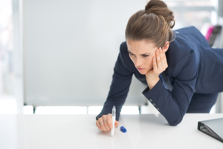 Stressed business woman near flipchartの写真素材