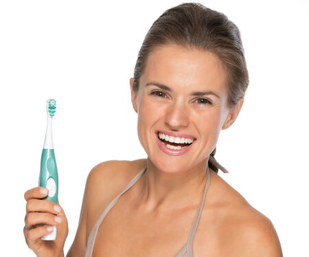 Portrait of smiling young woman with toothbrushのeditorial素材