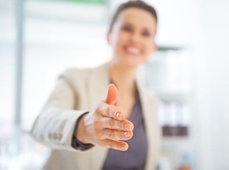 Closeup on happy business woman stretching hand for handshakeの写真素材