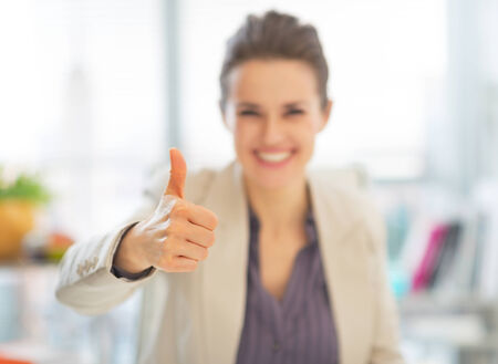 Closeup on smiling business woman showing thumbs upの写真素材