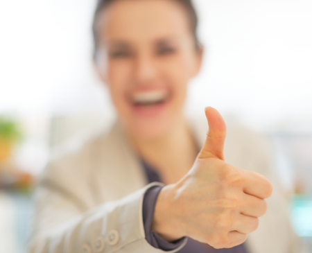 Closeup on happy business woman showing thumbs upの写真素材