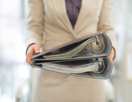 Closeup on business woman holding foldersの写真素材
