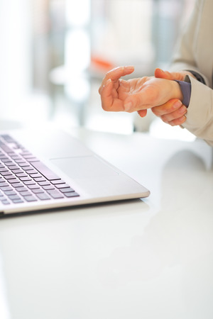 Closeup on business woman with wrist painの写真素材