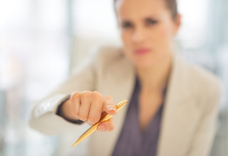 Closeup on business woman pointing with penの写真素材