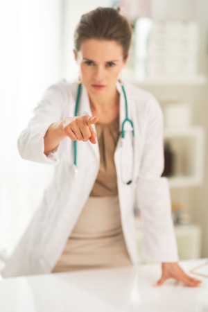 Closeup on medical doctor woman pointing in cameraの写真素材