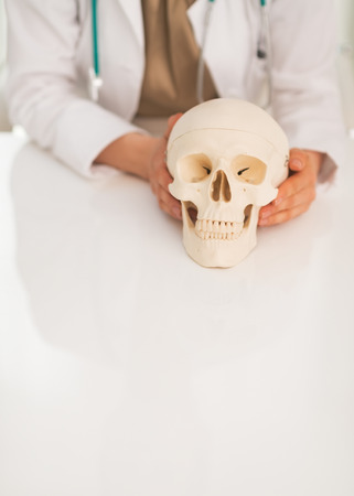 Closeup on medical doctor woman holding human skullの写真素材