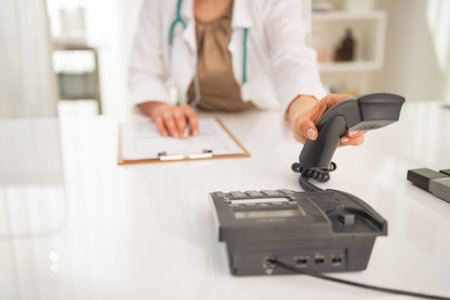 Closeup on medical doctor woman talking phoneの写真素材