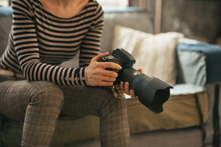 Closeup on young woman with modern dslr photo cameraの写真素材