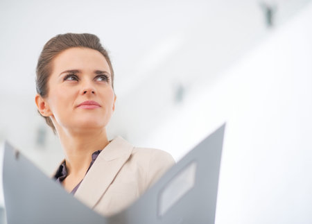 Portrait of business woman with folderの写真素材