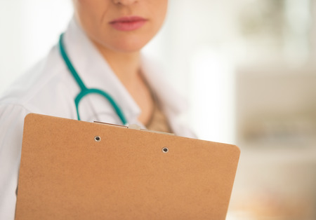 Closeup on doctor woman holding clipboardの写真素材