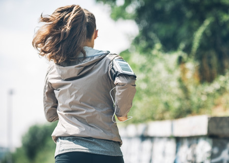 Fitness young woman jogging in the city park. rear viewの写真素材