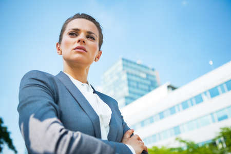 Portrait of serious business woman in front of office buildingの写真素材