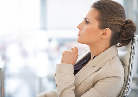 Portrait of thoughtful business woman in officeの写真素材