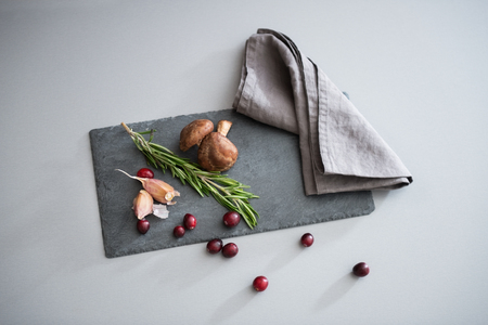 Closeup on mushrooms lingonberries and rosmarinus on tableの写真素材