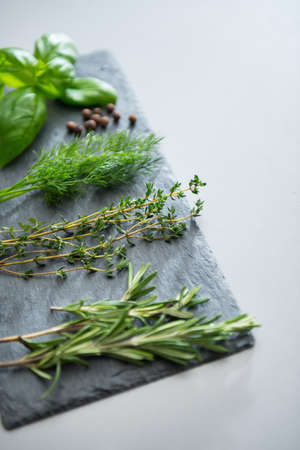 Closeup on fresh spices herbs on stone substrateの写真素材