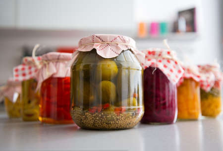 Closeup on jars of pickled vegetables on tableの写真素材