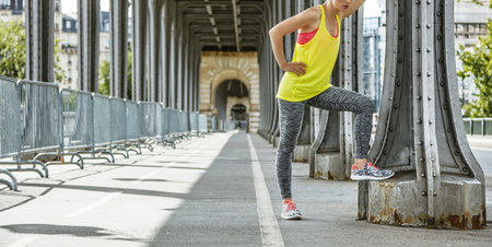 Outdoors fitness in Paris. Closeup on young woman jogger relaxing after workout on Pont de...