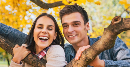 Portrait of smiling young couple outdoors in autumnの写真素材