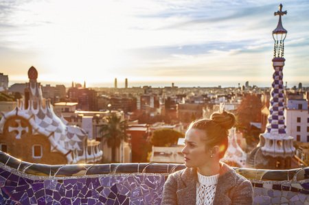 Barcelona signature style. elegant woman in coat at Guell Park in Barcelona, Spain looking asideの写真素材