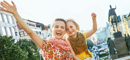 The spirit of old Europe in Prague. happy modern mother and daughter travellers on Wenceslas Square in Prague, Czech Republic rejoicingの写真素材