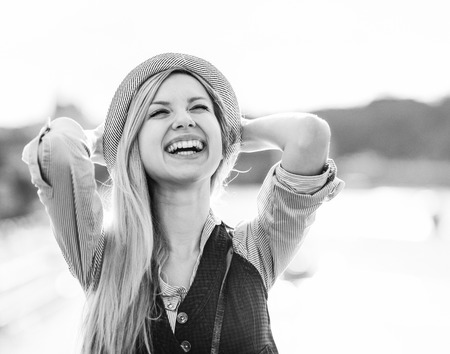 Portrait of happy hipster girl rejoicing in the cityの写真素材