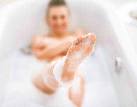 Closeup on young woman washing in bathtubの写真素材