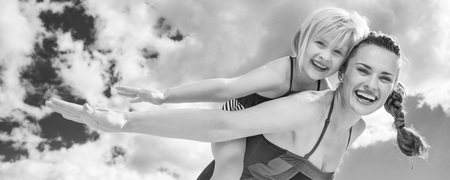 Sun kissed beauty. cheerful young mother and daughter in beachwear on the beach having fun timeの写真素材