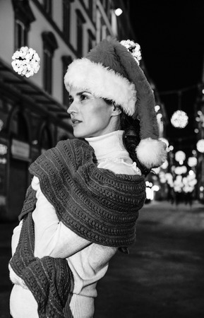 Trip full of inspiration at Christmas time in Florence. Portrait of modern woman in Christmas hat at Christmas in Florence, Italyの写真素材