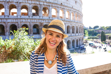 Roman Holiday. Portrait of happy young woman near Colosseum in Rome, Italyの写真素材