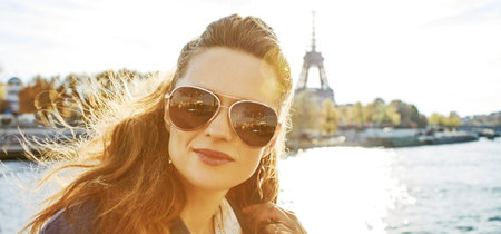 Autumn getaways in Paris. Portrait of young elegant woman in sunglasses on embankment in Paris,...