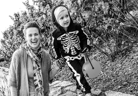 Trick or Treat. smiling modern mother and daughter on Halloween at the park playingの写真素材