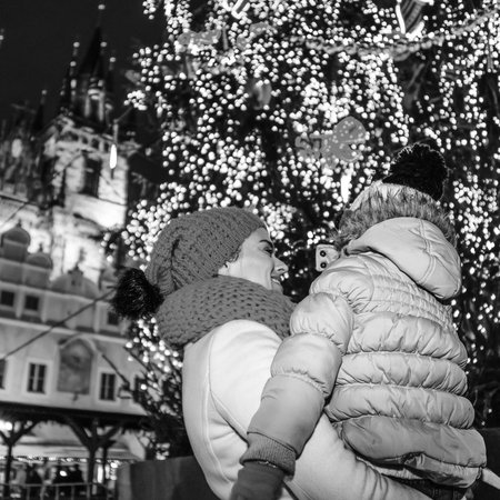Magic on streets of the old town at Christmas. Seen from behind young mother and daughter travellers at Christmas in Prague Czech Republicの写真素材