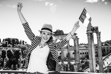 Roman Holiday. happy elegant woman in Rome, Italy with Italian flag rejoicingの写真素材