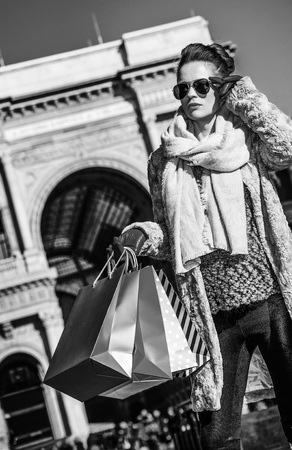 Rediscovering things everybody love in Milan. elegant woman in fur coat and sunglasses near Galleria Vittorio Emanuele II in Milan, Italy looking into the distanceの写真素材