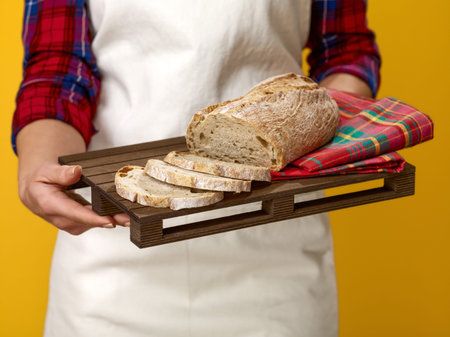 Healthy food to your table. Closeup on modern woman farmer wearing apron isolated on yellow...