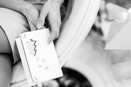 Closeup on young woman holding christmas postcardの写真素材