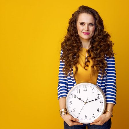 young woman in striped jacket on yellow background with clock