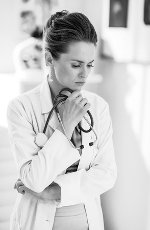 Portrait of thoughtful medical doctor woman in officeの写真素材
