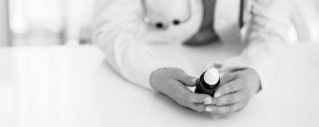 Closeup on medical doctor woman holding medicine bottleの写真素材