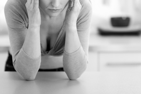 Closeup on stressed young housewife in kitchenの写真素材