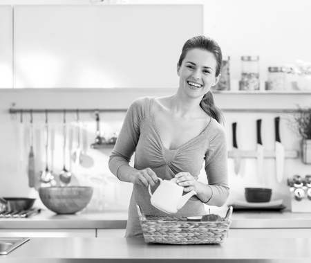 Smiling young housewife serving breakfast trayの写真素材