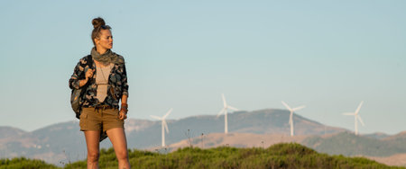 active tourist woman in hiking clothes in nature looking aside