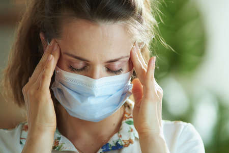 Life during covid-19 pandemic. Closeup on woman in white blouse disinfecting hands with sanitizer.の写真素材
