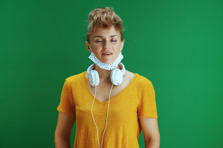 Life during covid-19 pandemic. Portrait of modern student woman in yellow shirt with textbooks,...