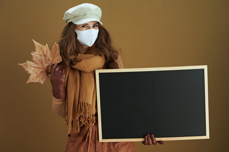 Life during coronavirus pandemic. cheerful elegant 40 years old housewife in scarf with white...
