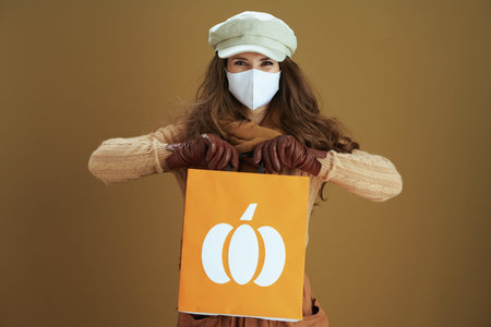 Life during coronavirus pandemic. cheerful elegant 40 years old housewife in scarf with white...