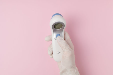 covid flat lay with cleaning cloth, rubber gloves, medical mask and an antibacterial agent on white...